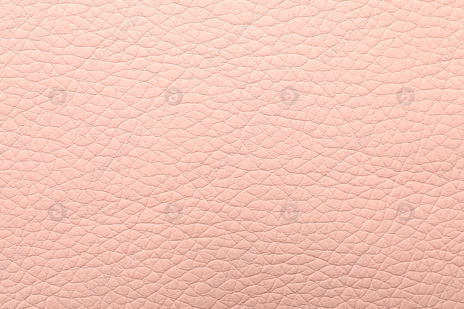 Photo of Texture of light pink leather as background, closeup