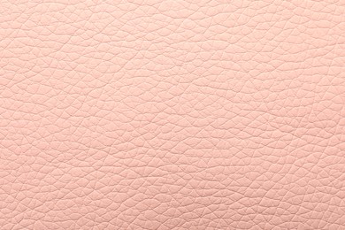 Photo of Texture of light pink leather as background, closeup