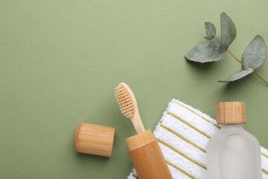 Photo of Flat lay composition with bamboo toothbrush on green background, space for text