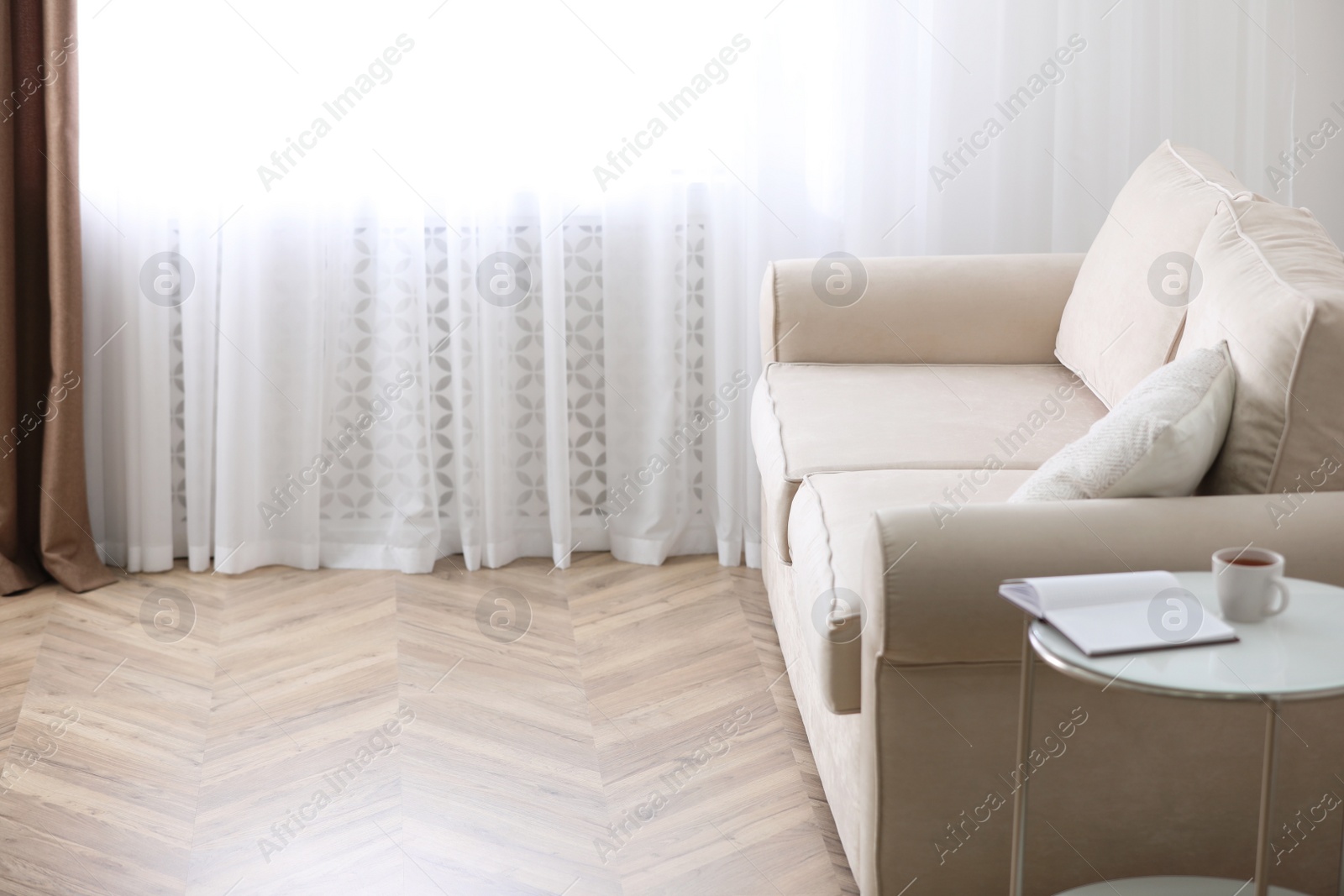 Photo of Parquet floor in room with sofa and coffee table