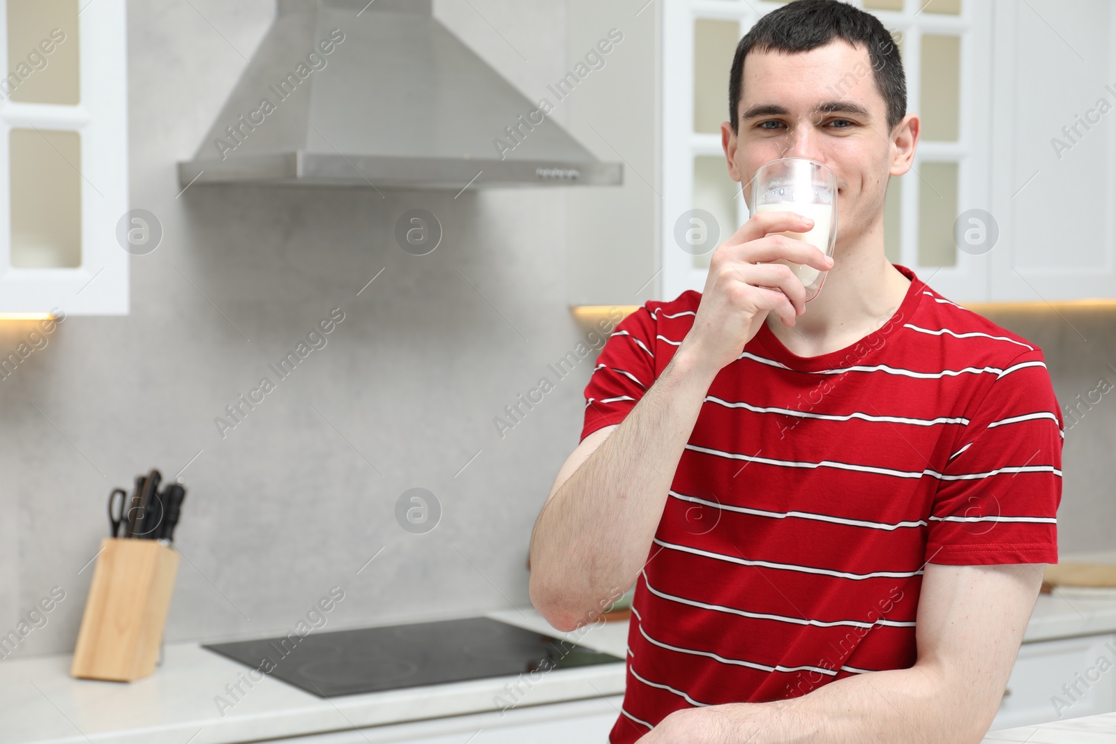 Photo of Man drinking tasty milk in kitchen at home