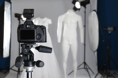 Photo of Taking pictures of ghost mannequins with modern clothes in professional photo studio, focus on camera