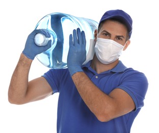 Photo of Courier in medical mask holding bottle for water cooler on white background. Delivery during coronavirus quarantine