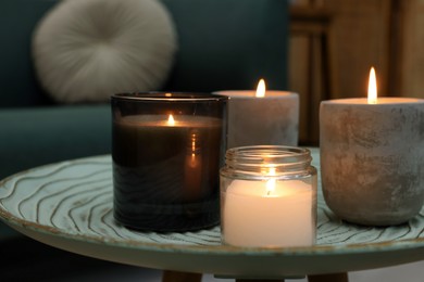 Photo of Lit candles on table in living room