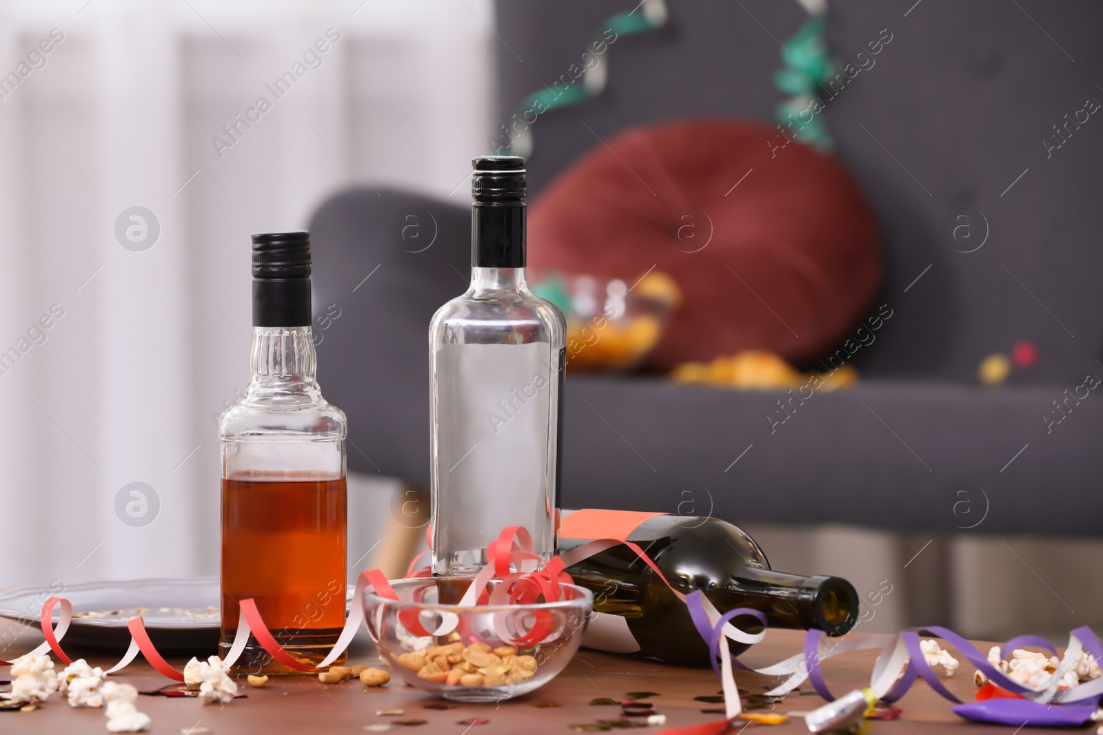 Photo of Messy table with bottles after party indoors, closeup