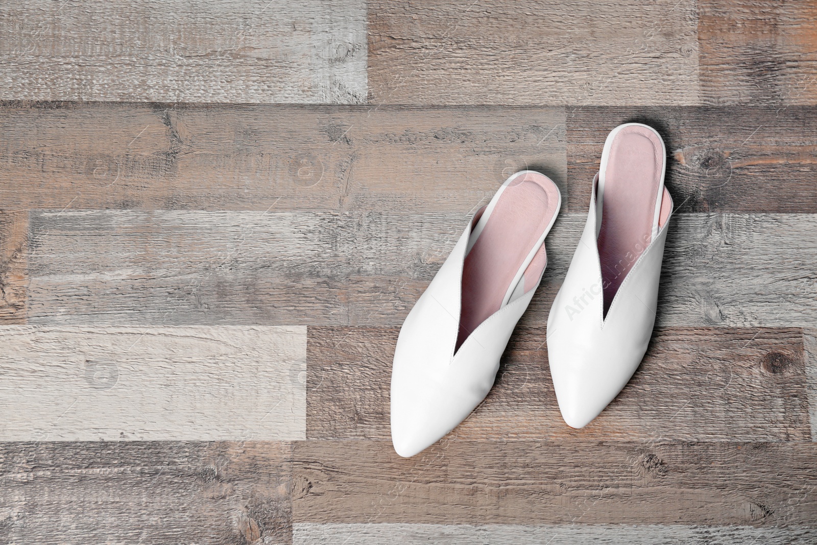 Photo of Pair of female shoes on wooden background, top view