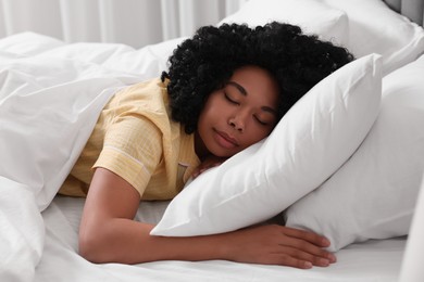 Photo of Beautiful young woman sleeping in soft bed