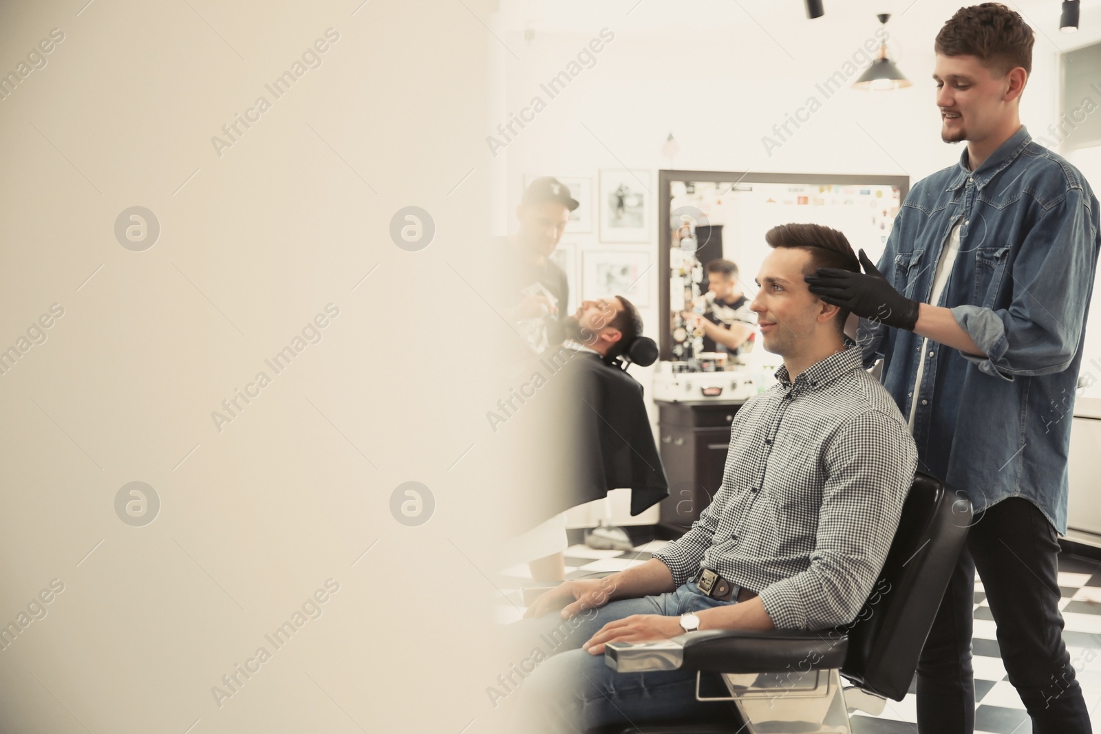 Photo of Professional barber working with client in hairdressing salon. Hipster fashion