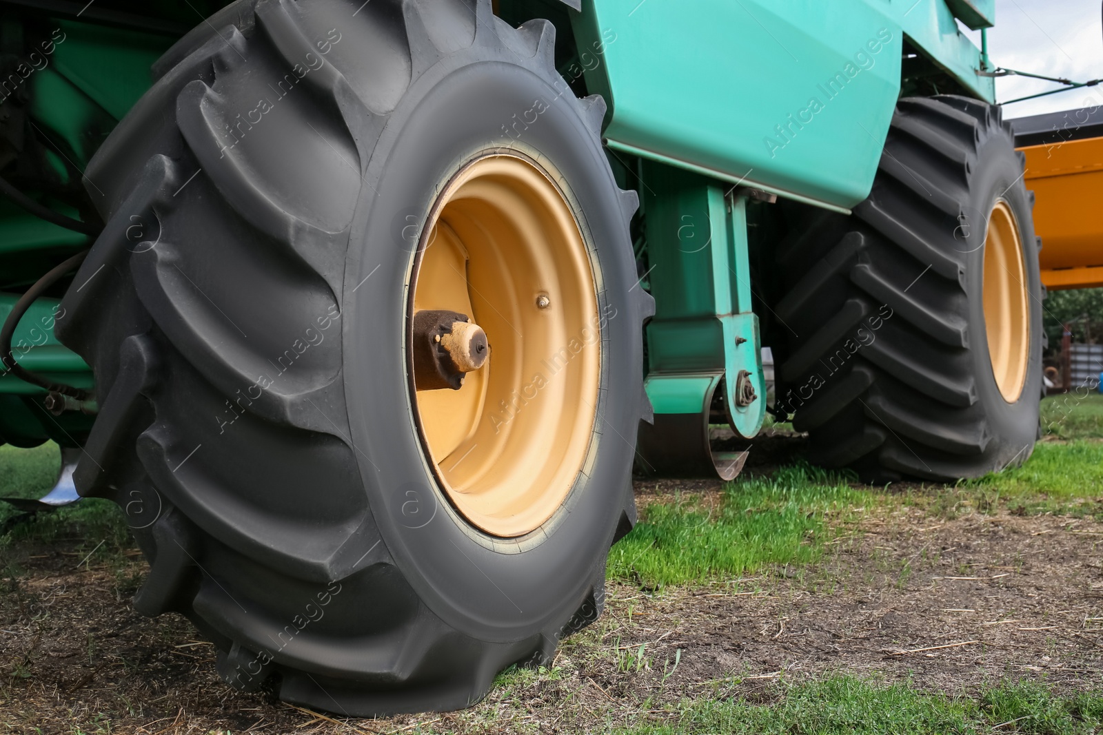 Photo of Modern combine harvester wheels outdoors, closeup view