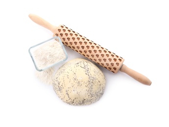 Photo of Raw dough with poppy seeds, flour in bowl and rolling pin on white background