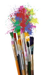 Different brushes and paint splatters on white background