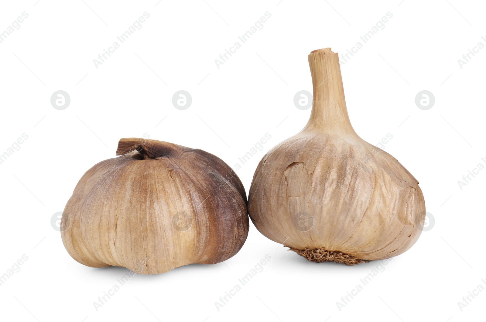 Photo of Bulbs of fermented black garlic isolated on white