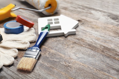 Set of decorator's tools on wooden background, closeup