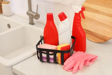 Photo of Different cleaning supplies on counter in kitchen