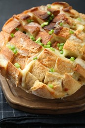 Freshly baked bread with tofu cheese and green onions on table, closeup