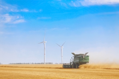 Photo of Modern combine harvester working in agricultural field