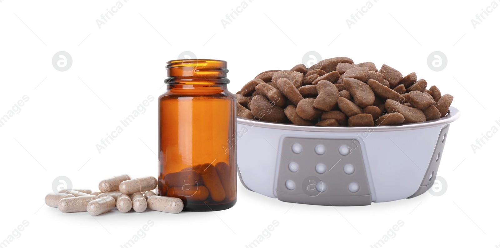 Image of Dry pet food in feeding bowl and bottle with vitamin pills on white background