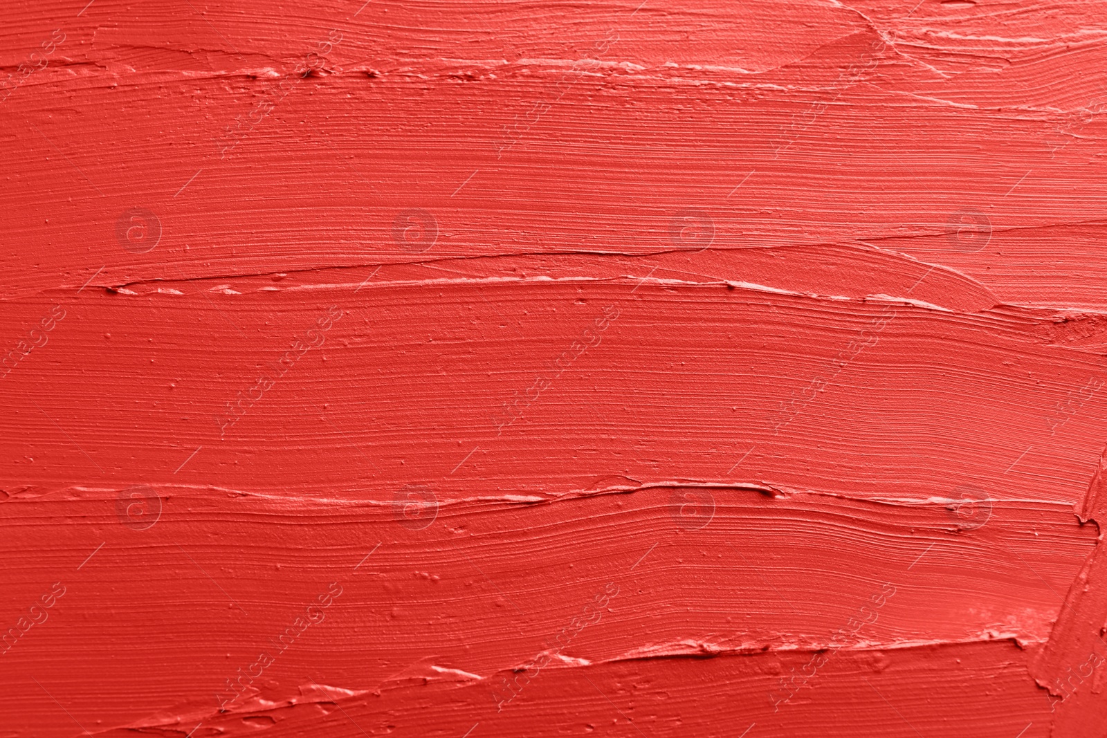 Photo of Red lipstick smears as background, closeup. Cosmetic product