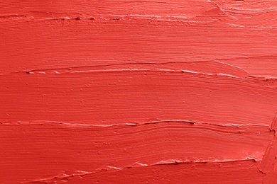 Photo of Red lipstick smears as background, closeup. Cosmetic product