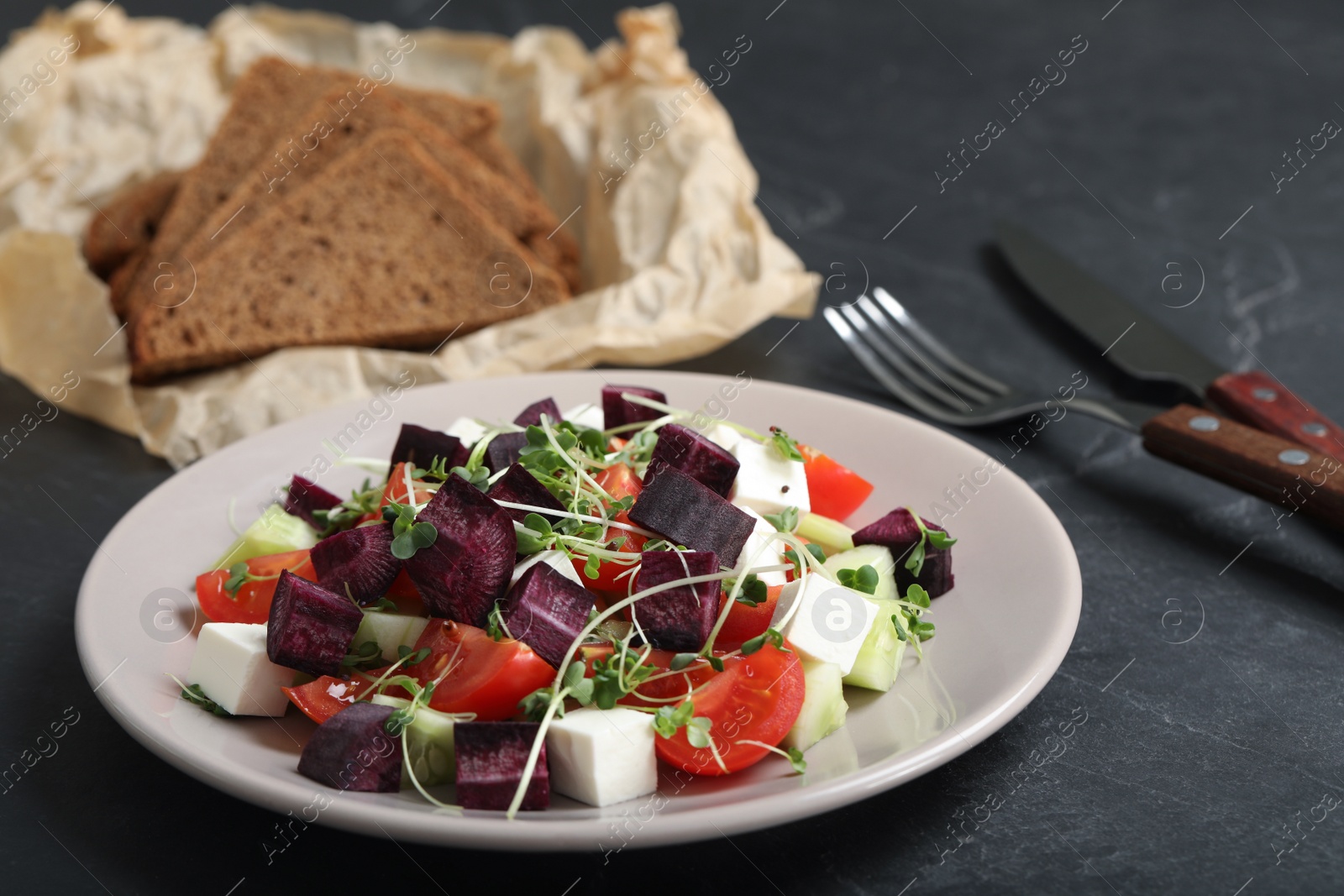 Photo of Delicious carrot salad served on black table, closeup