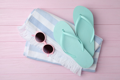 Beach objects on pink wooden background, flat lay