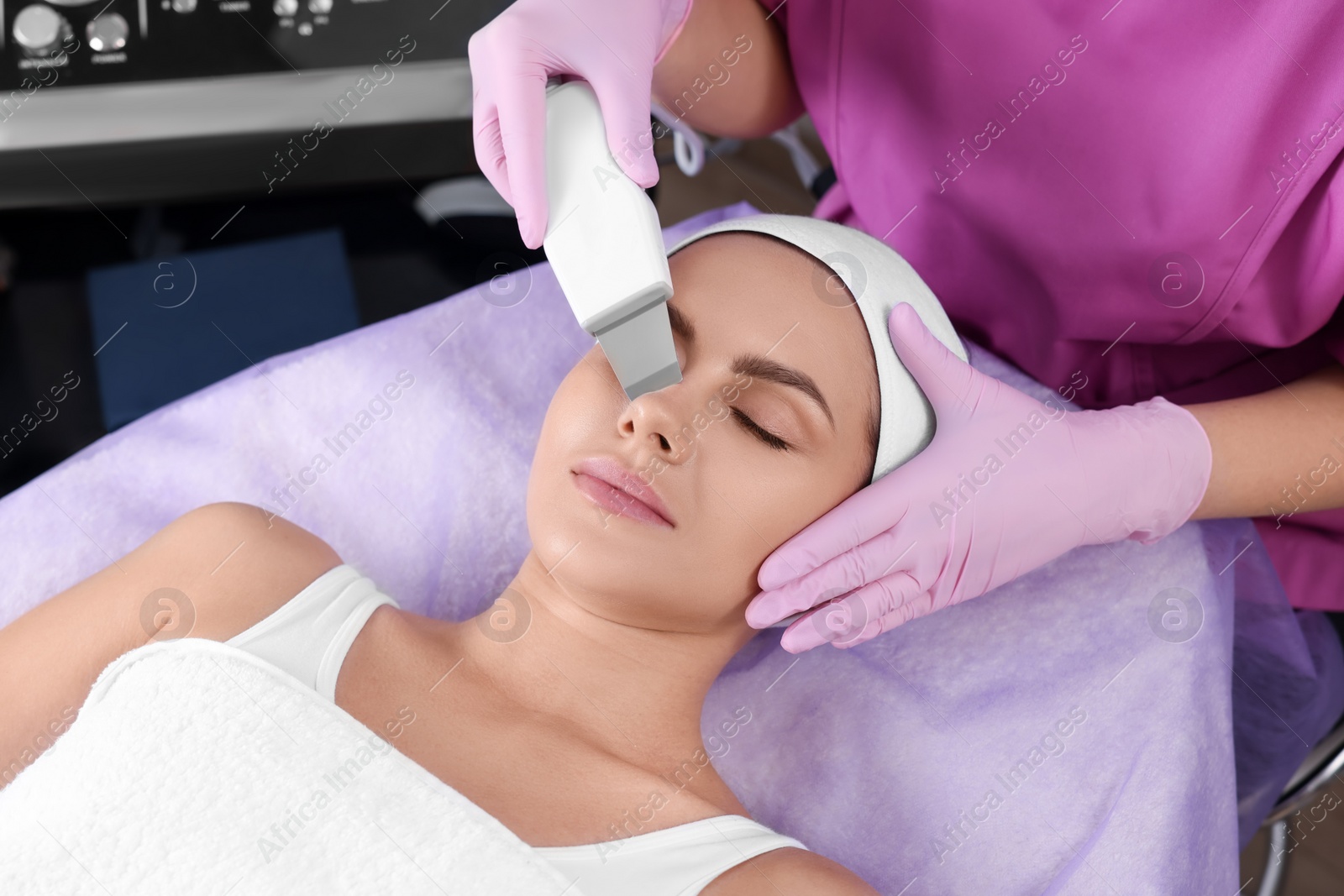 Photo of Young woman undergoing cosmetic procedure in beauty salon. Microcurrent therapy