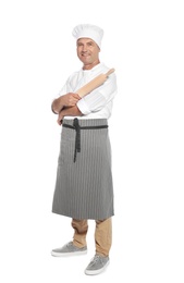 Mature male chef holding rolling pin on white background