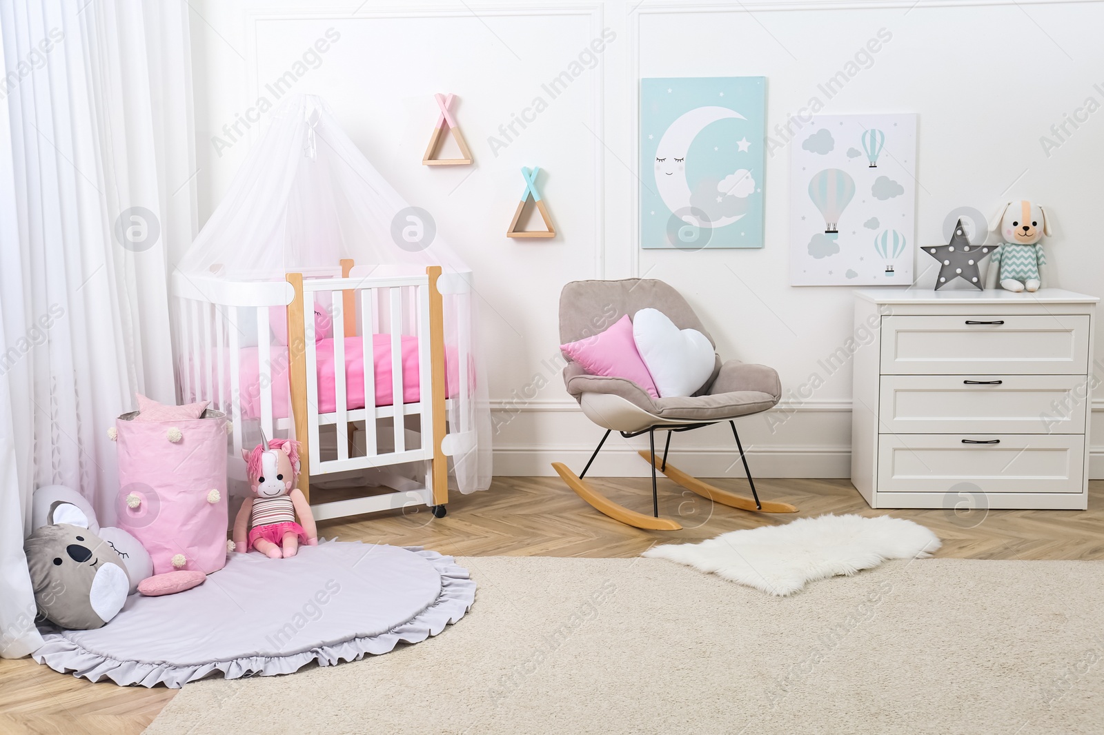 Photo of Baby room interior with toys and stylish furniture