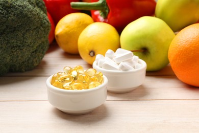 Dietary supplements. Bowls with different pills near food products on light wooden table, closeup