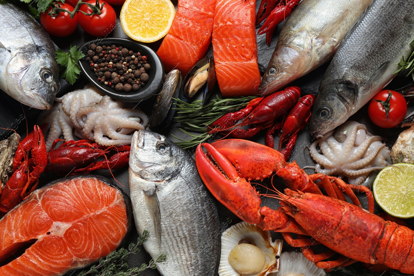 Photo of Fresh fish and different seafood on table, flat lay