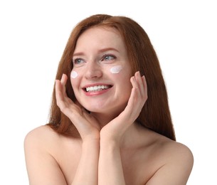 Smiling woman with freckles and cream on her face against white background
