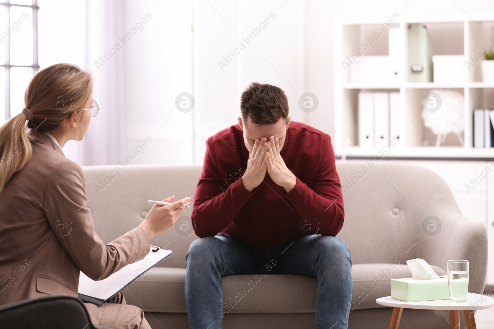 Photo of Psychotherapist working with young man in office