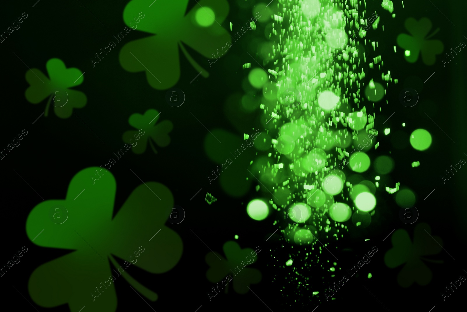 Image of St. Patrick's Day celebration. Clover leaves on black background, bokeh effect