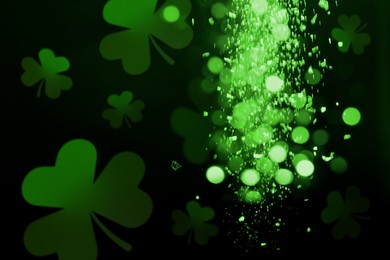 Image of St. Patrick's Day celebration. Clover leaves on black background, bokeh effect