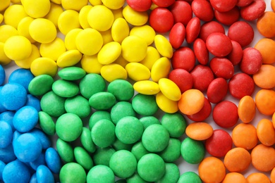 Photo of Many colorful candies as background, top view