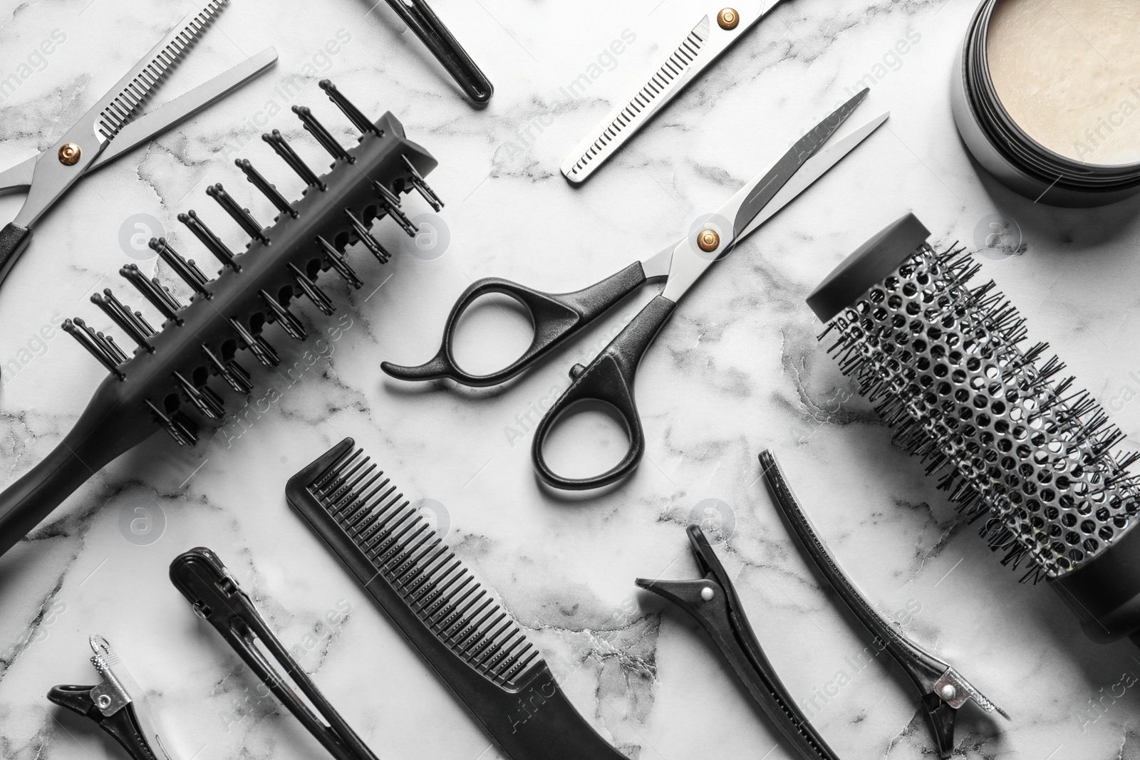 Photo of Flat lay composition with scissors and other hairdresser's accessories on white marble background