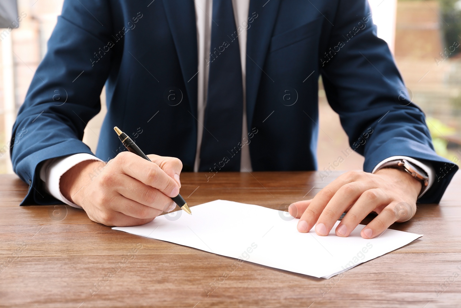 Photo of Lawyer working with documents at table, focus on hands