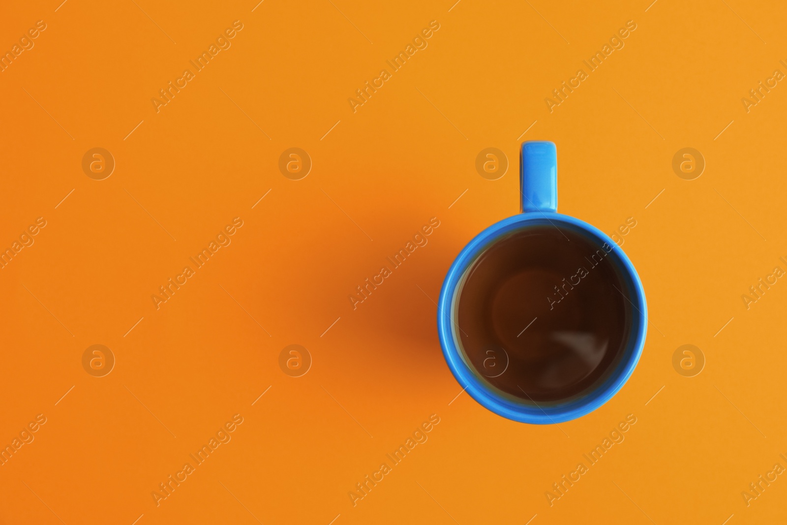 Photo of Cup of tea on coral background, top view. Space for text