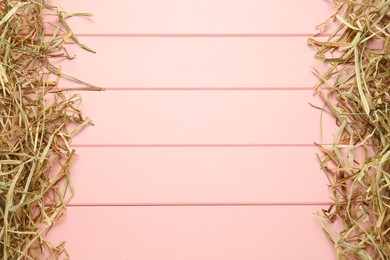 Photo of Dried hay on pink wooden background, flat lay. Space for text