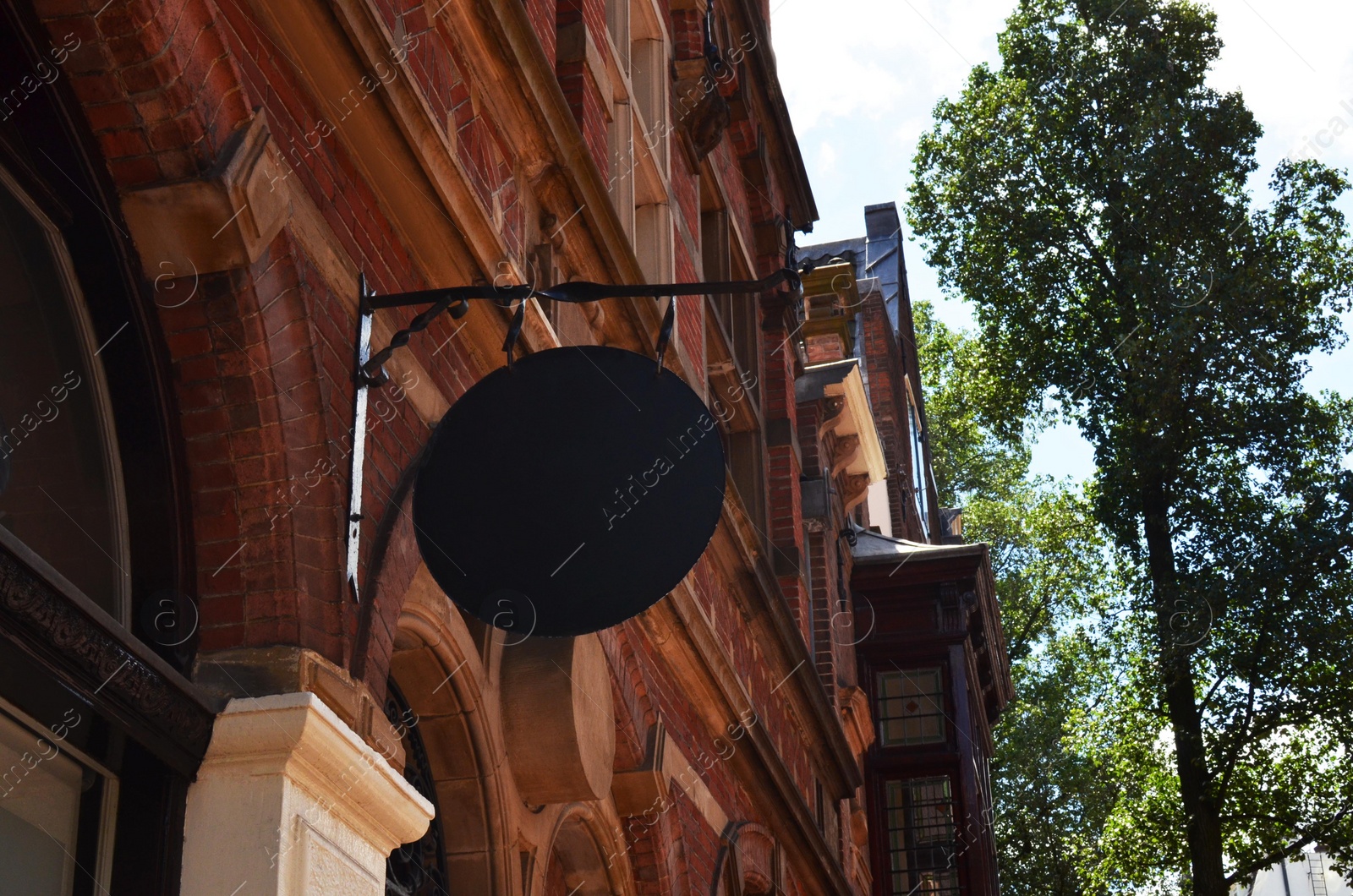 Photo of Beautiful building facade with signboard, low angle view