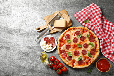 Photo of Flat lay composition with hot pepperoni pizza on grey  table. Space for text