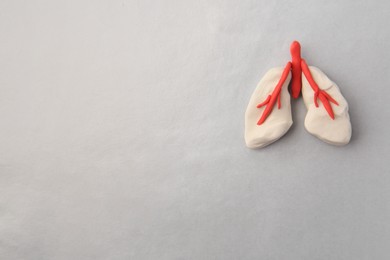 Human lungs made of plasticine on grey background, top view. Space for text