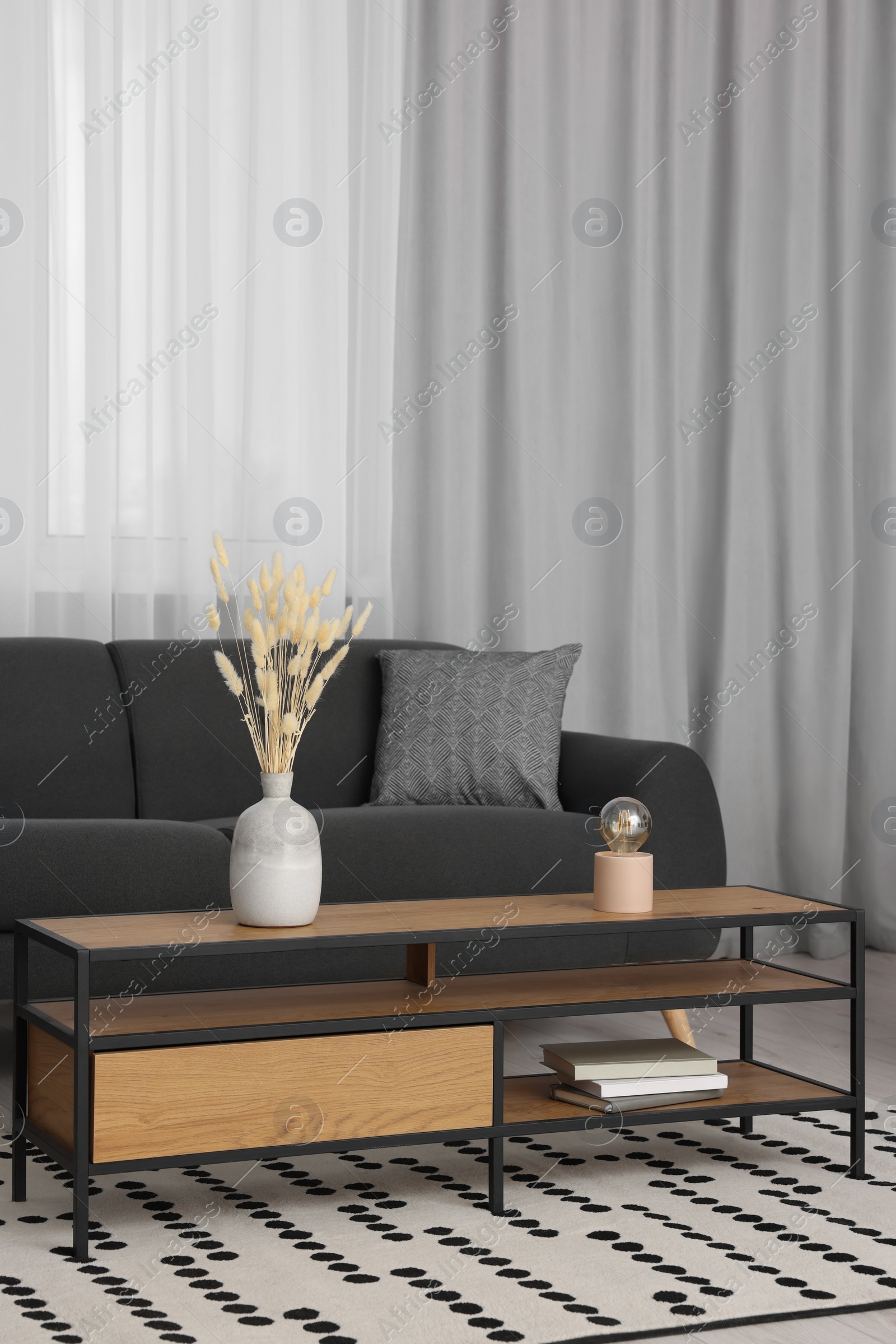 Photo of Stylish living room interior with comfortable furniture and beautiful window curtains