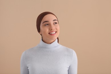 Smiling woman with cancer on beige background. Space for text