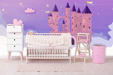 Image of Baby room interior with crib and other furniture. Fairytale themed wallpapers with castle
