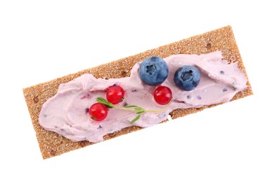 Photo of Tasty cracker sandwich with cream cheese, blueberries, red currants and thyme isolated on white, top view