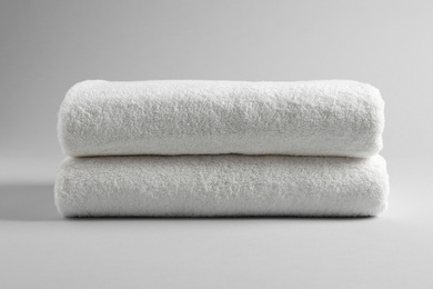 Fresh soft folded towels on light background