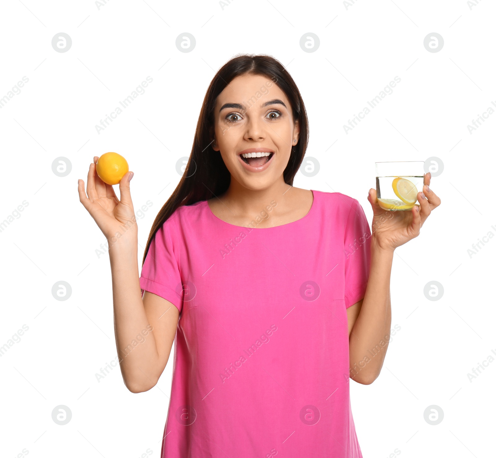 Photo of Excited young woman with tasty lemon water and fresh fruit on white background