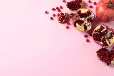 Photo of Composition with ripe pomegranates and space for text on color background, top view