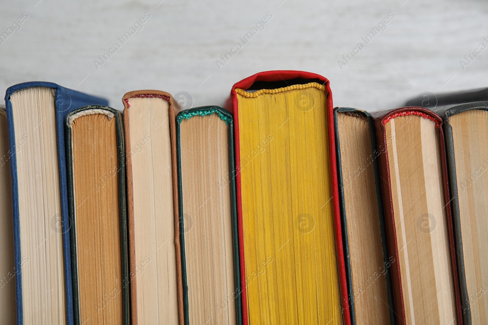 Photo of Stack of hardcover books on white background, closeup